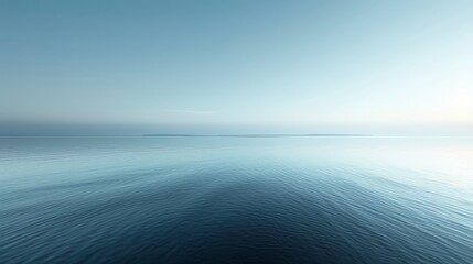 Calm ocean expanse under blue skies