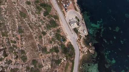 Malta, Mistra bay, Aerial view of the emerald water with corals and coastal road, High quality 4k footage