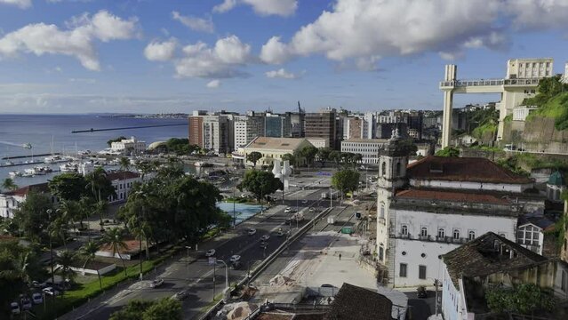 Drone flies past Lacerda Elevator and over Mercado Modelo in Salvador, Bahia, Brazil