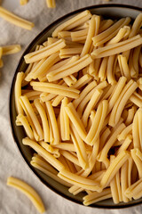 Dry Casarecce Pasta in a Bowl, top view. Close-up.