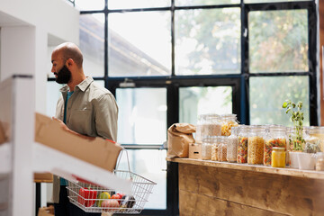 Middle Eastern man browsing different food items in other sections of the store. Male consumer...