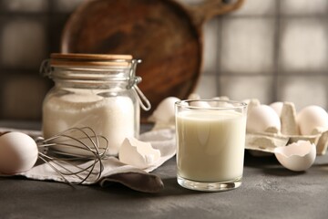 Different ingredients for dough on grey table, closeup