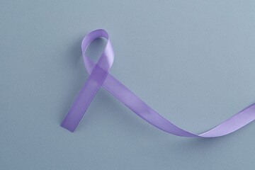 Violet awareness ribbon on light blue background, top view