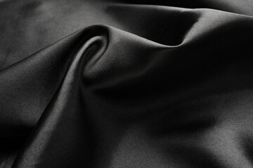 Crumpled black silk fabric as background, closeup