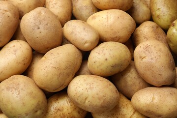 Fresh raw potatoes as background, top view