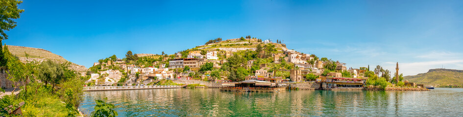 Halfeti village and its submerged minaret and Turkish flags of toursit boats sunken minaret in Halfeti - TURKEY. landscape photo