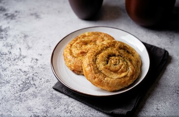 Spiral filo dough Greek pie with filling in a plate