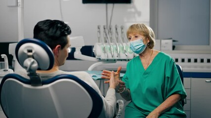 in a dental clinic the dentist and the patient happily shake hands with each other