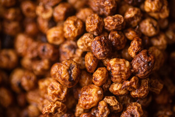 Close shot dry large orange tiger nuts wet with water and clean