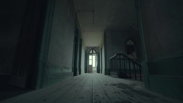 Scary, empty, dark and haunted corridor with staircase, windows and doors in an old abandoned house (4K, Dolly in travelling shot, ProRes 422 HQ)