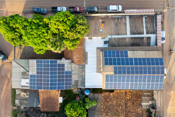 Aerial drone view of urban block with buildings equipped with photovoltaic panels on the rooftops...