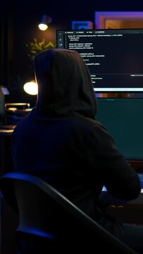 Vertical video Happy man writing code on PC, celebrating after managing to get past security systems. Hacker using computer to make scripts that can hack devices, feeling proud after breaching