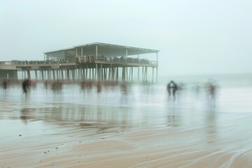 Ethereal beach scene with blurred figures and a solid pier structure captured in a long exposure shot