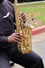 man playing saxophone at the farmers market