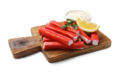 Tasty crab sticks, sauce, parsley and lemon wedge isolated on white