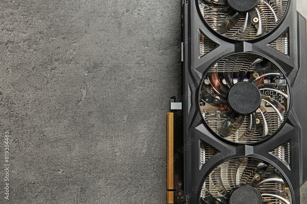 Fototapete one computer graphics card on grey textured table, top view. space for text