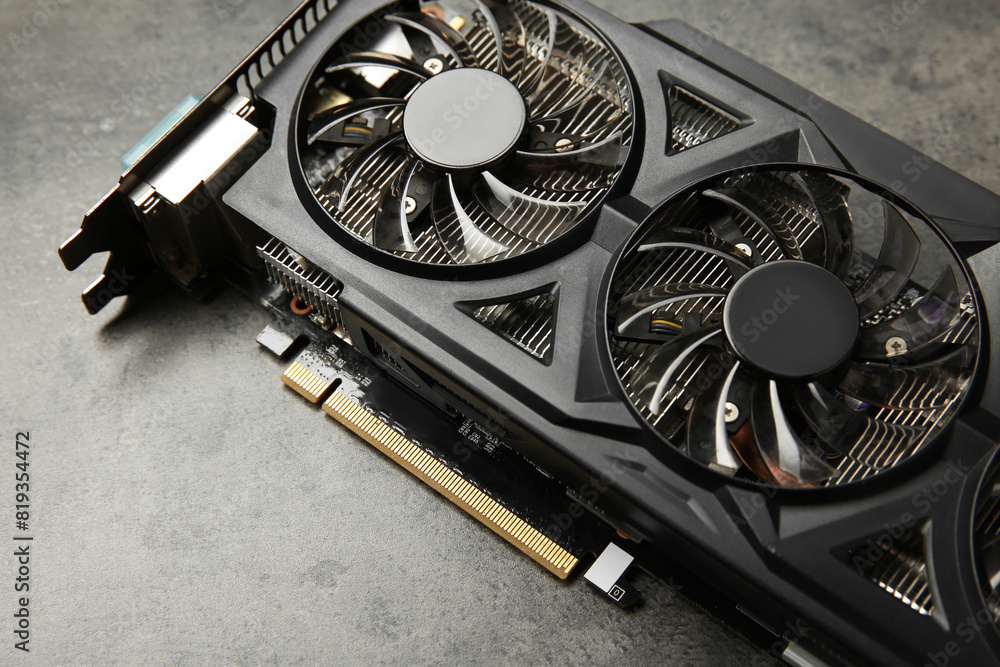 Fototapete one computer graphics card on grey textured table, above view