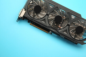 One graphics card on light blue background, top view. Space for text