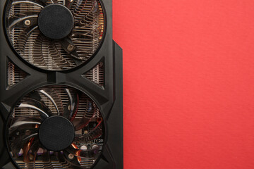 One graphics card on red background, top view. Space for text