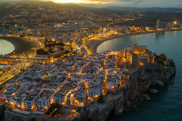 Aerial view of Peniscola beach and castle at twilight on Costa del Azahar, Spain