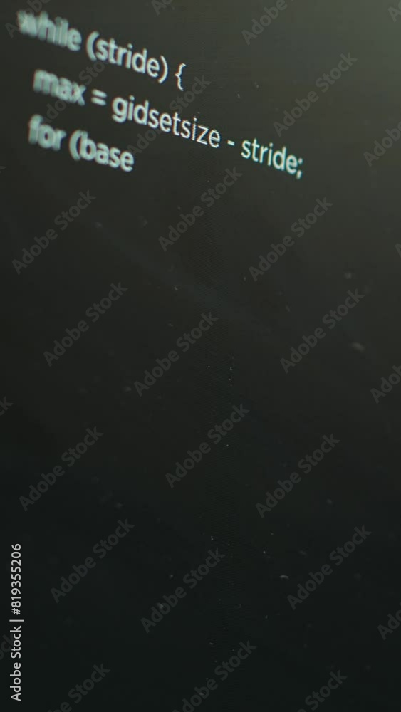 Poster vertical video extreme close up shot of lines of code displayed on computer monitors used by cybercr