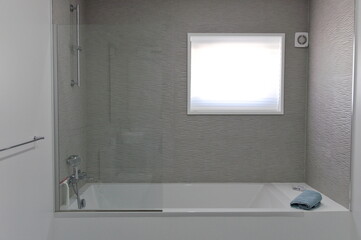 bathroom in light colors with bathtup