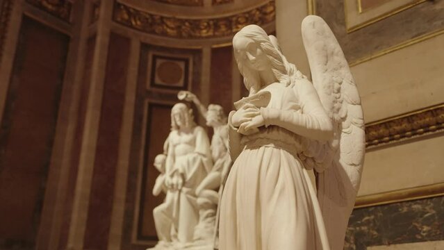 Paris, France - Angel statue in La Madeleine Church, built in the early 19th century in the neoclassical style of a Roman temple, Paris, France.