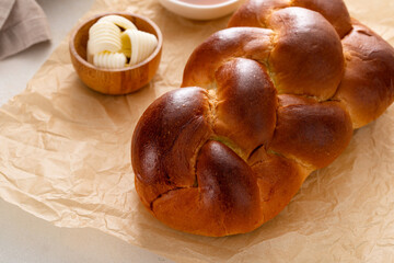 Homemade sliced challah bread with butter and honey