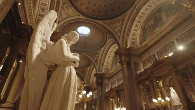 Paris, France - Angel statue in La Madeleine Church, built in the early 19th century in the neoclassical style of a Roman temple, Paris, France.