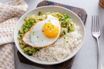 Fresh sauteed leafy greens with rice and topped with fried egg