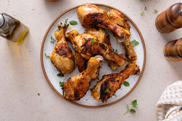 Juicy roasted or grilled chicken drumsticks on plate © fahrwasser