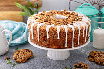 Glazed bundt cake with cookie crumbles on kitchen counter