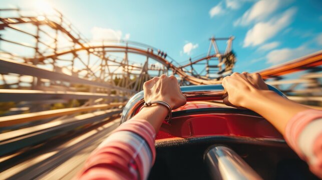 Hand gripping the safety bar on a roller coaster ride with the tracks and sky visible - Powered by Adobe