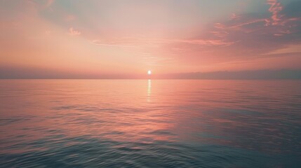 Obraz premium The morning sky over a calm sea, reflecting hues of pink and gold as the sun rises above the horizon.