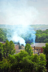 Old factory chimney with smoke