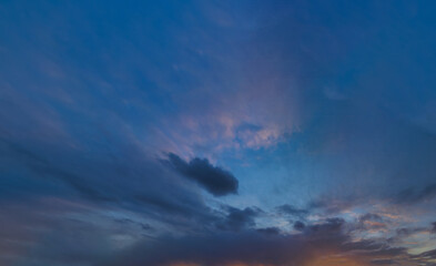 Real amazing panoramic sunrise or sunset sky with gentle colorful clouds. Long panorama.