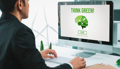 Businessman working in office developing plan or project on eco-friendly alternative energy with...