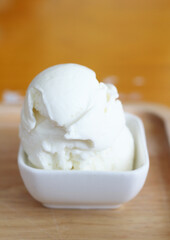 Delicious ice cream in a cup on a wooden table
