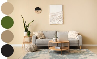 Interior of living room with comfortable sofa, table and laptop. Different color patterns