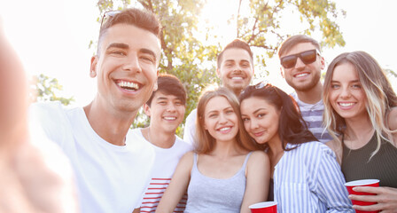 Obraz premium Group of attractive young people taking selfie outdoors