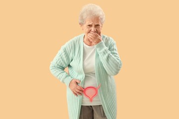 Senior woman suffering from cystitis on beige background