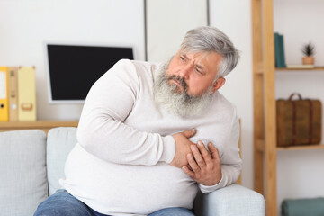 Elderly man having heart attack at home