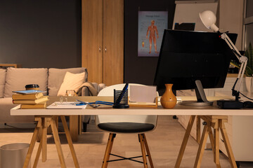 Nurse's workplace with computer at hospital in evening