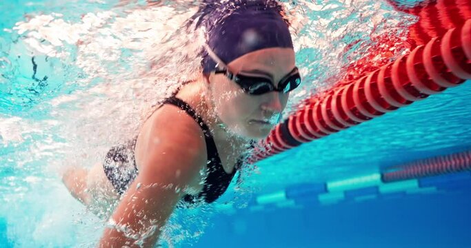 Swimming, athlete and woman in water with cap for performance training, competition or challenge. Sports, pool and swimmer with goggles for fitness, race contest or endurance exercise underwater