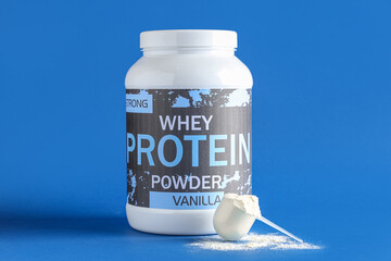 Bottle of protein powder and scoop on color background
