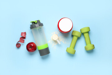Obraz premium Composition with protein powder, bottle, dumbbells and measuring tape on color background