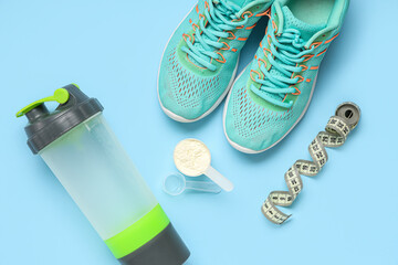 Scoop with protein powder, sports water bottle, shoes and measuring tape on color background