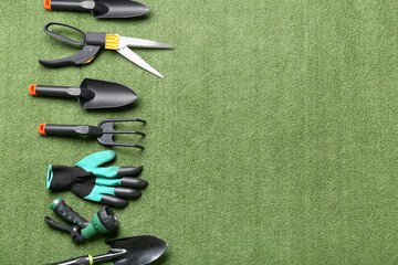 Tools for gardening on green grass background. Top view