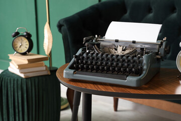 Vintage typewriter on table in living room, closeup