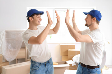 Loaders giving each other high-five in room